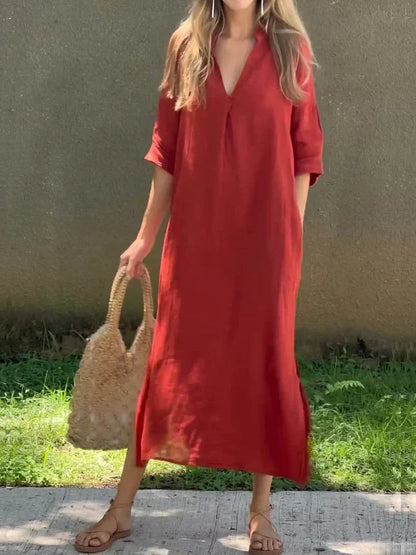 Woman wearing a red dress holding a straw bag outdoors.
