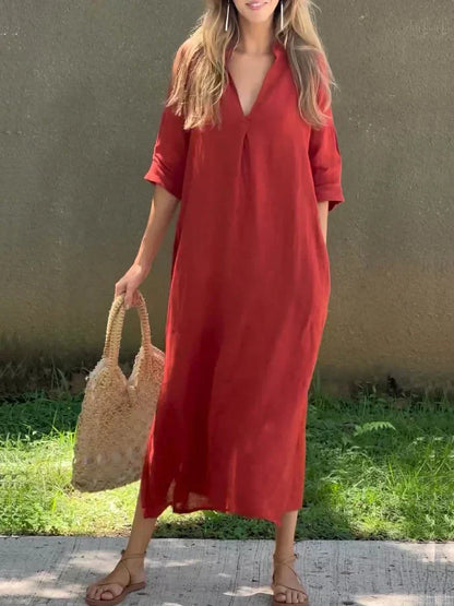 Woman in a red dress holding a straw bag against a neutral background