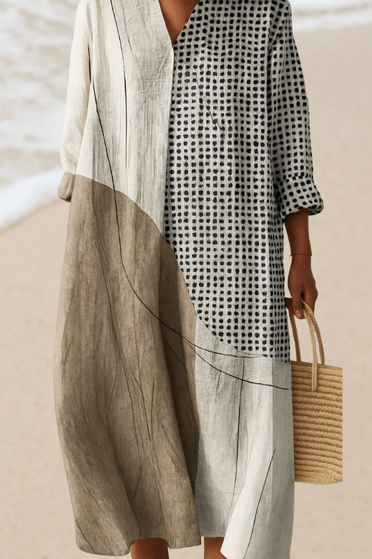 Person wearing a black and white checkered dress with a beige cover-up on a beach.