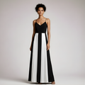 Woman wearing a black and white dress on a plain background