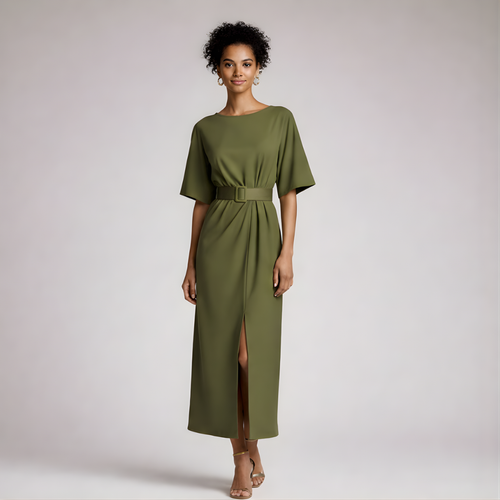 Woman wearing a green dress with a belt on a plain background