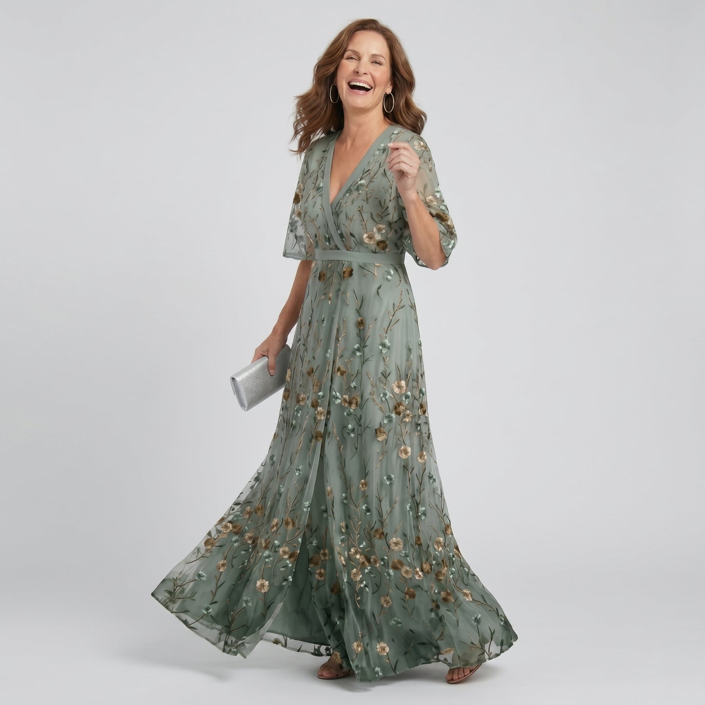Woman wearing a green floral dress on a gray background