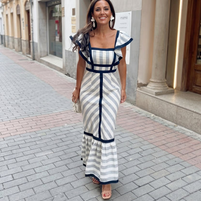 Woman in a striped dress walking on a city street