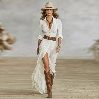 Woman in a white dress with a brown belt and boots, standing on a wooden floor.