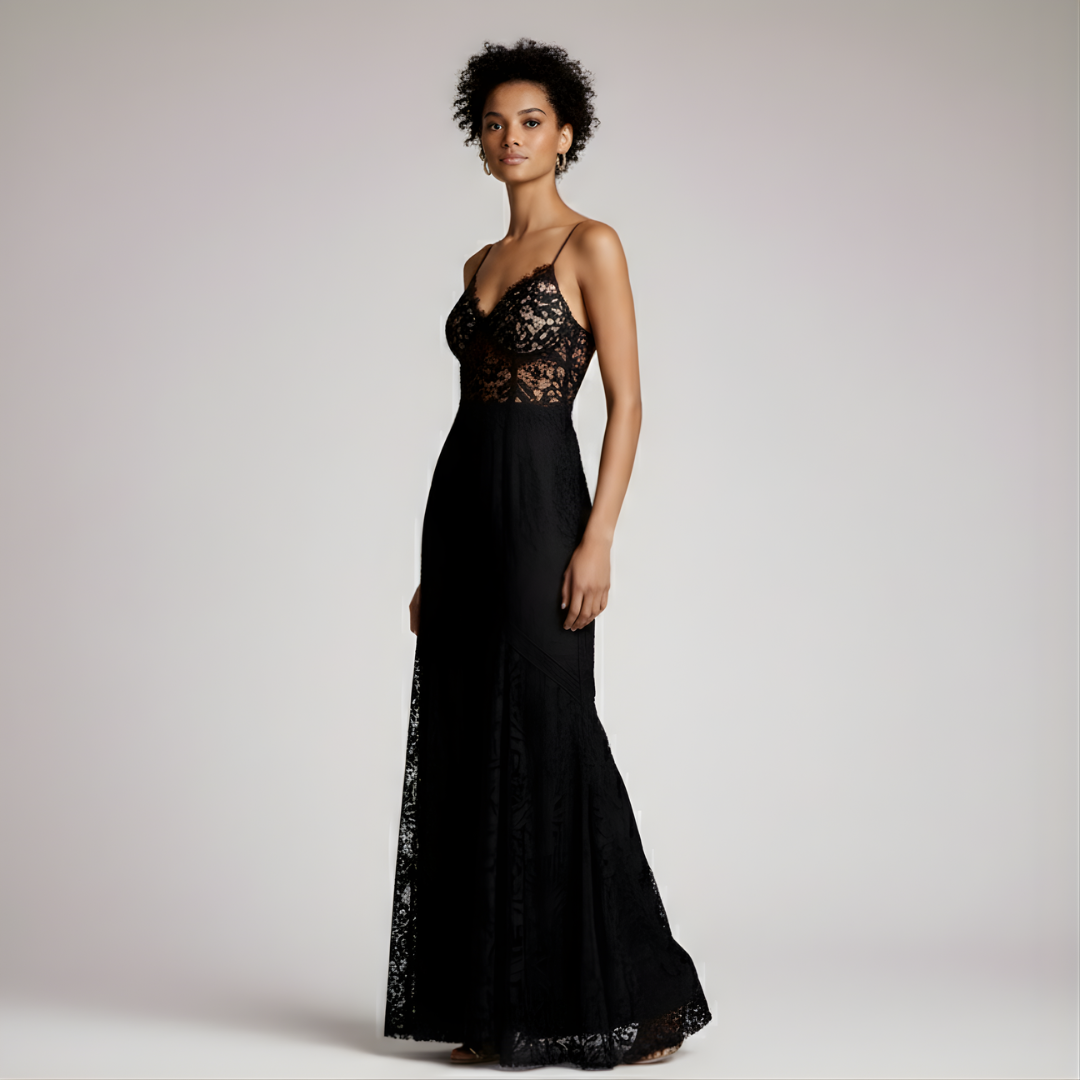 Woman wearing a black lace evening gown against a plain background