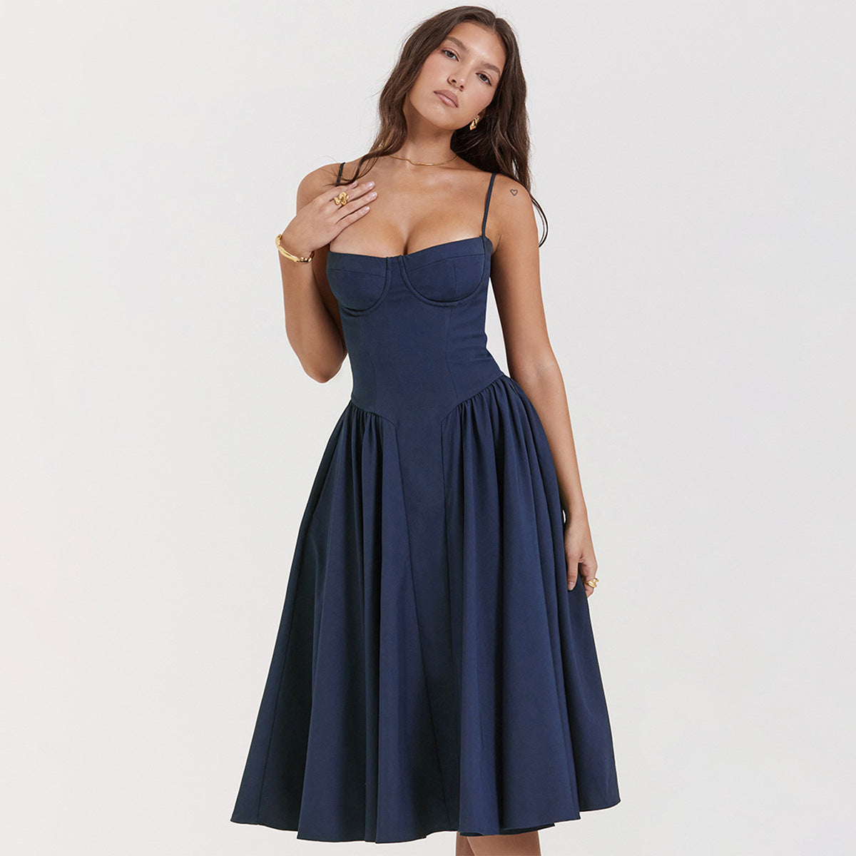 Woman wearing a navy blue dress on a white background