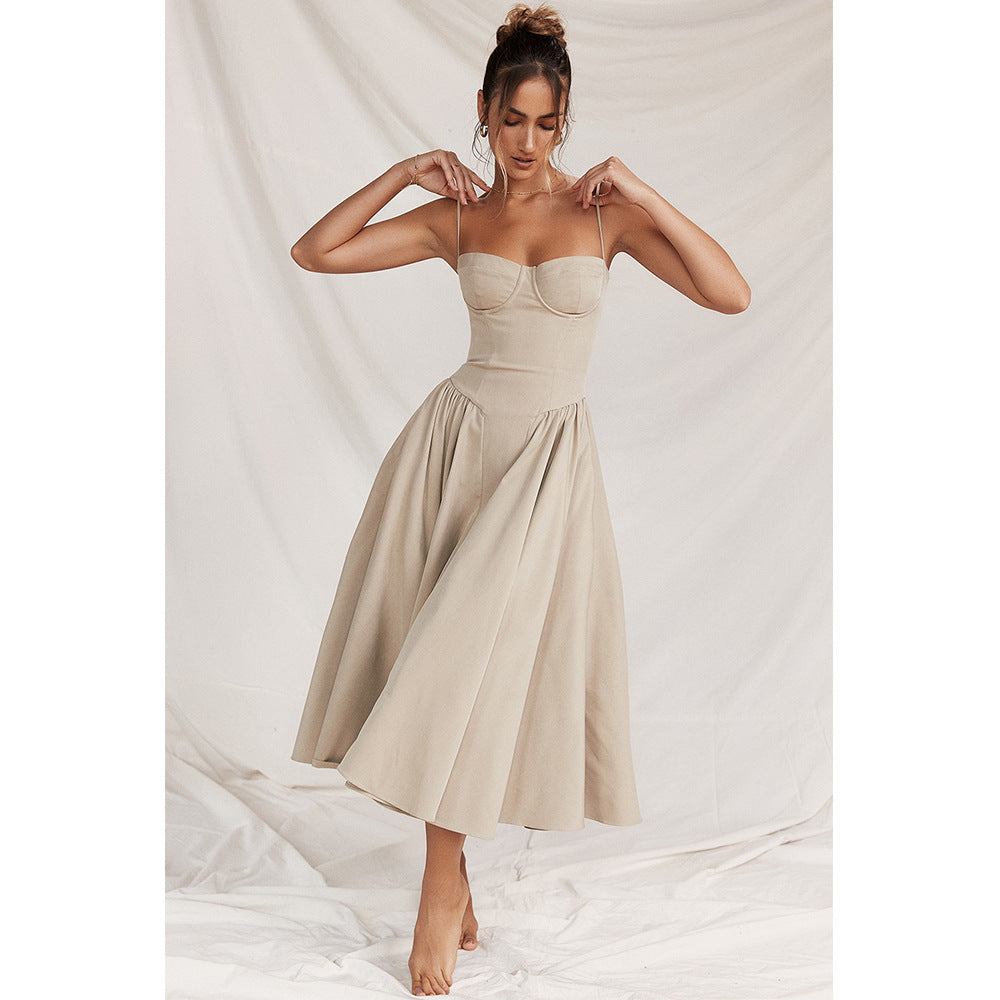 Woman wearing a beige dress against a white background