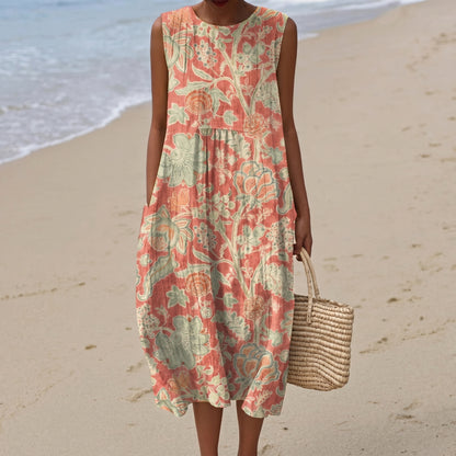 Woman in a floral dress on a beach holding a woven bag