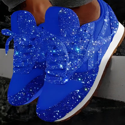 Blue glittery sneakers with a white sole on a dark background
