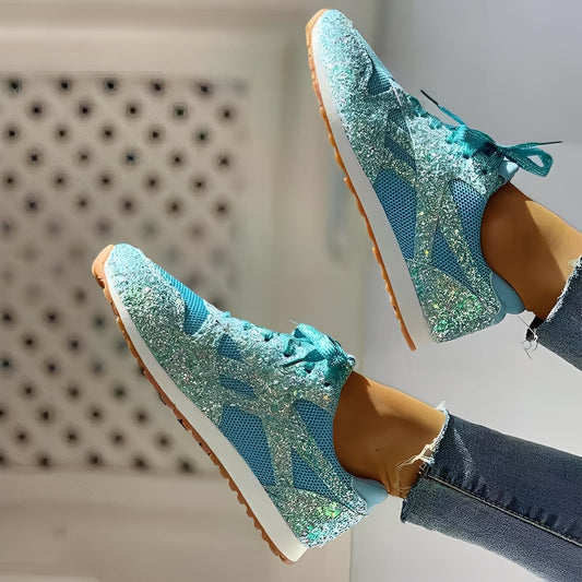 Blue glittery sneakers worn with jeans on a neutral background