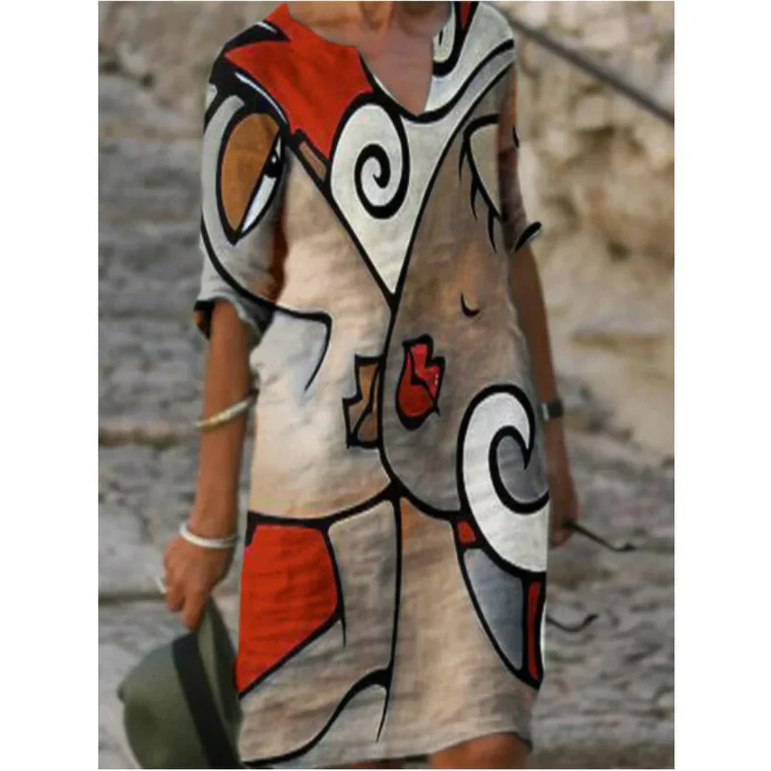 Person wearing a colorful abstract patterned dress with a stone wall background