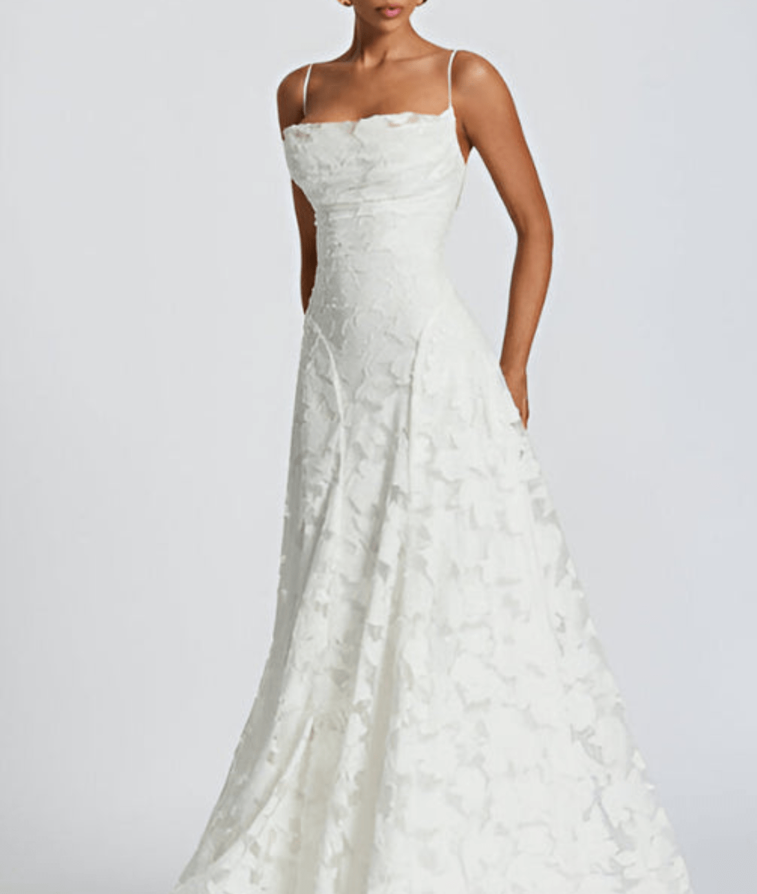 White lace wedding dress on a plain background