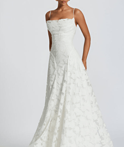 White lace wedding dress on a plain background