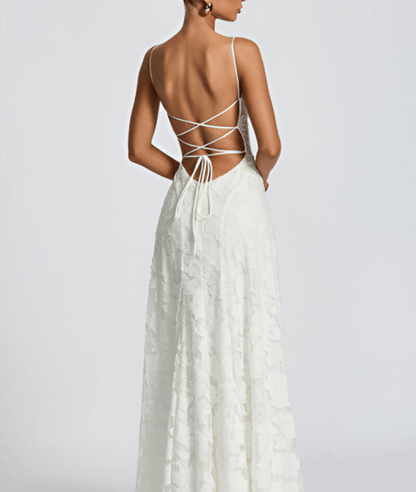 White dress with open back on a plain background