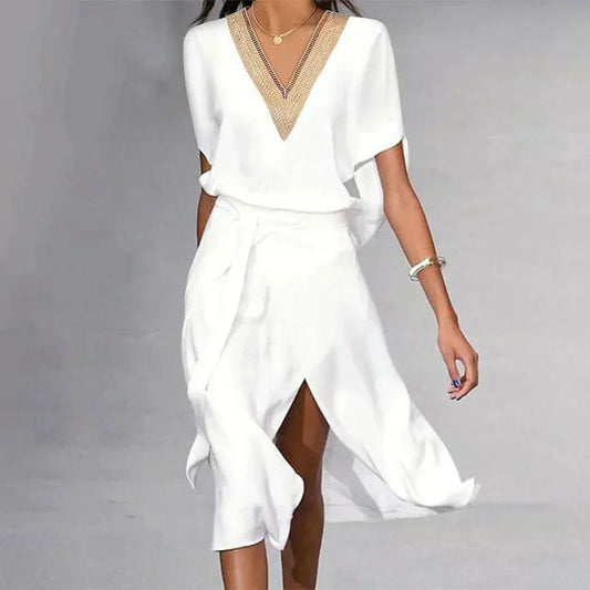 White dress with gold neckline on a gray background