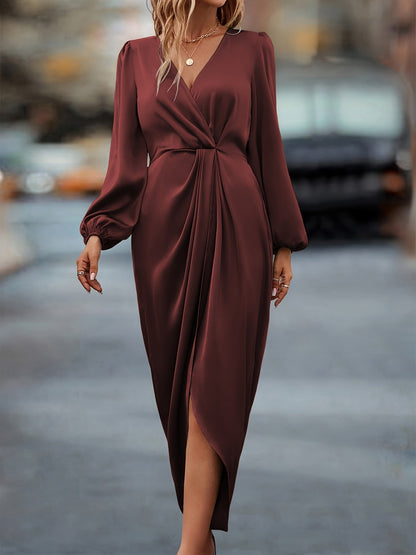 Woman wearing a burgundy dress on a blurred street background