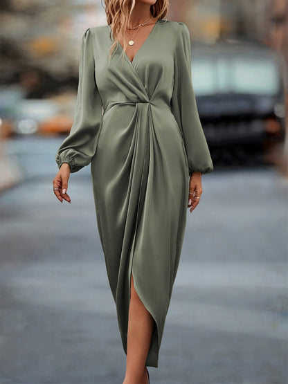 Woman wearing a green dress on a blurred city street background