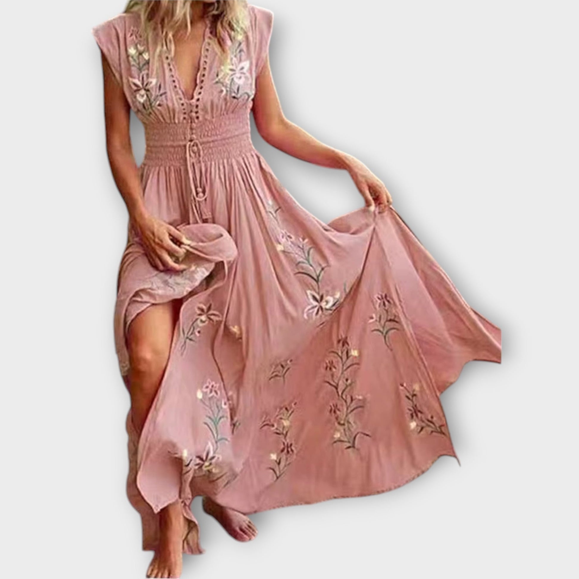 Pink dress with floral embroidery on a white background