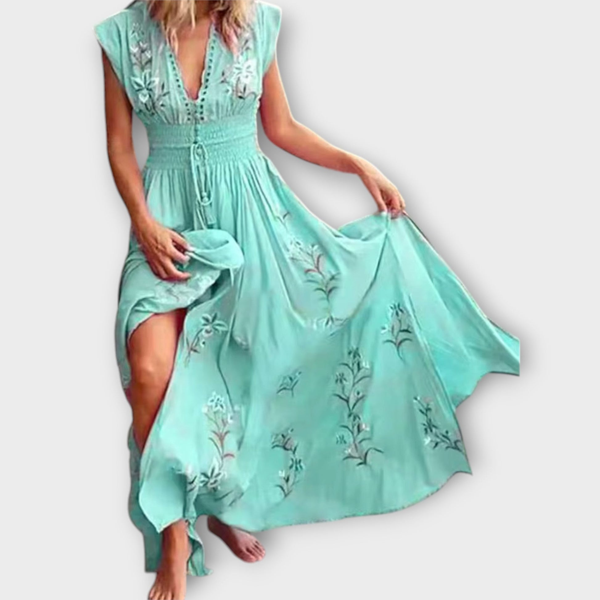 Mint green dress with floral embroidery on a white background