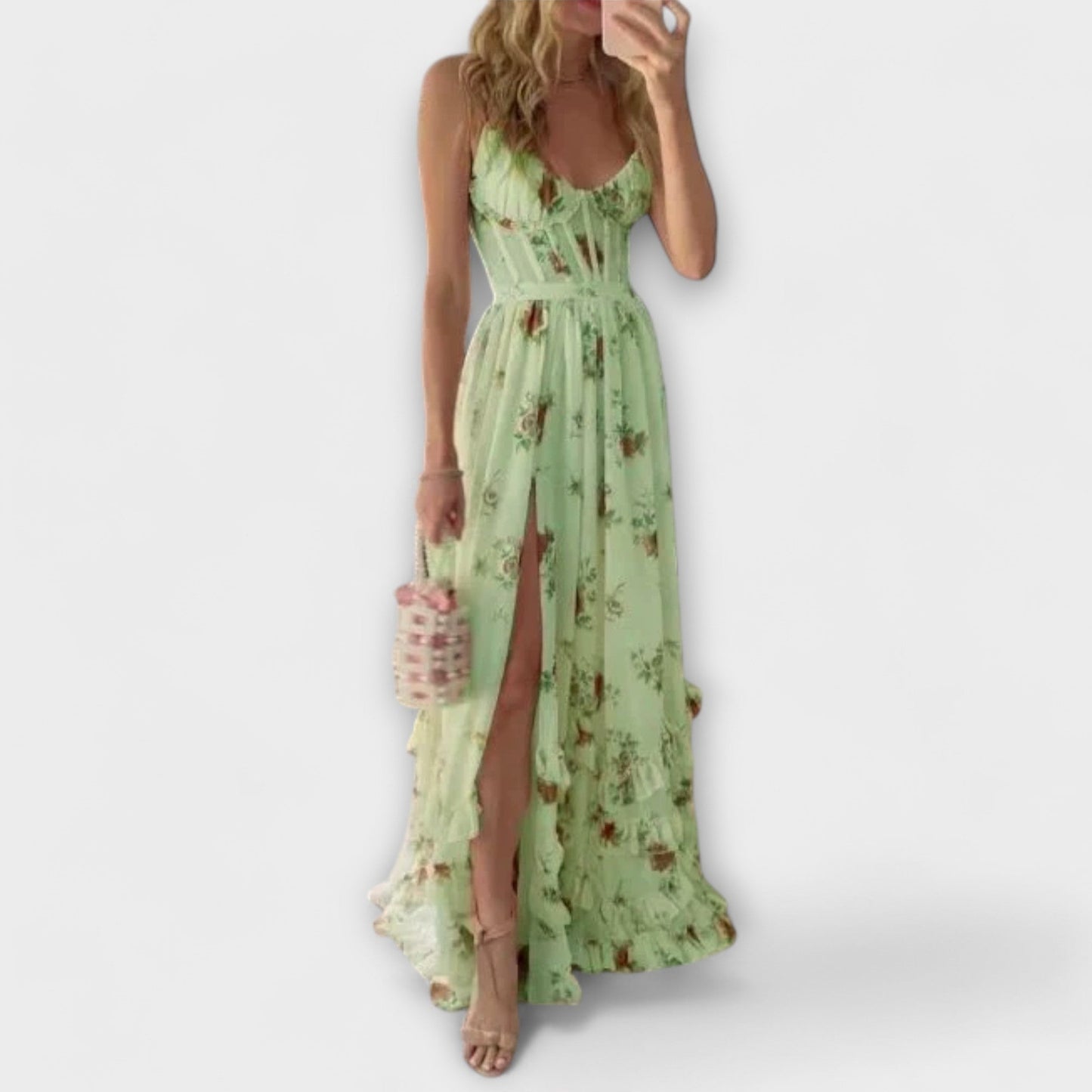 Woman wearing a green floral dress with a white background