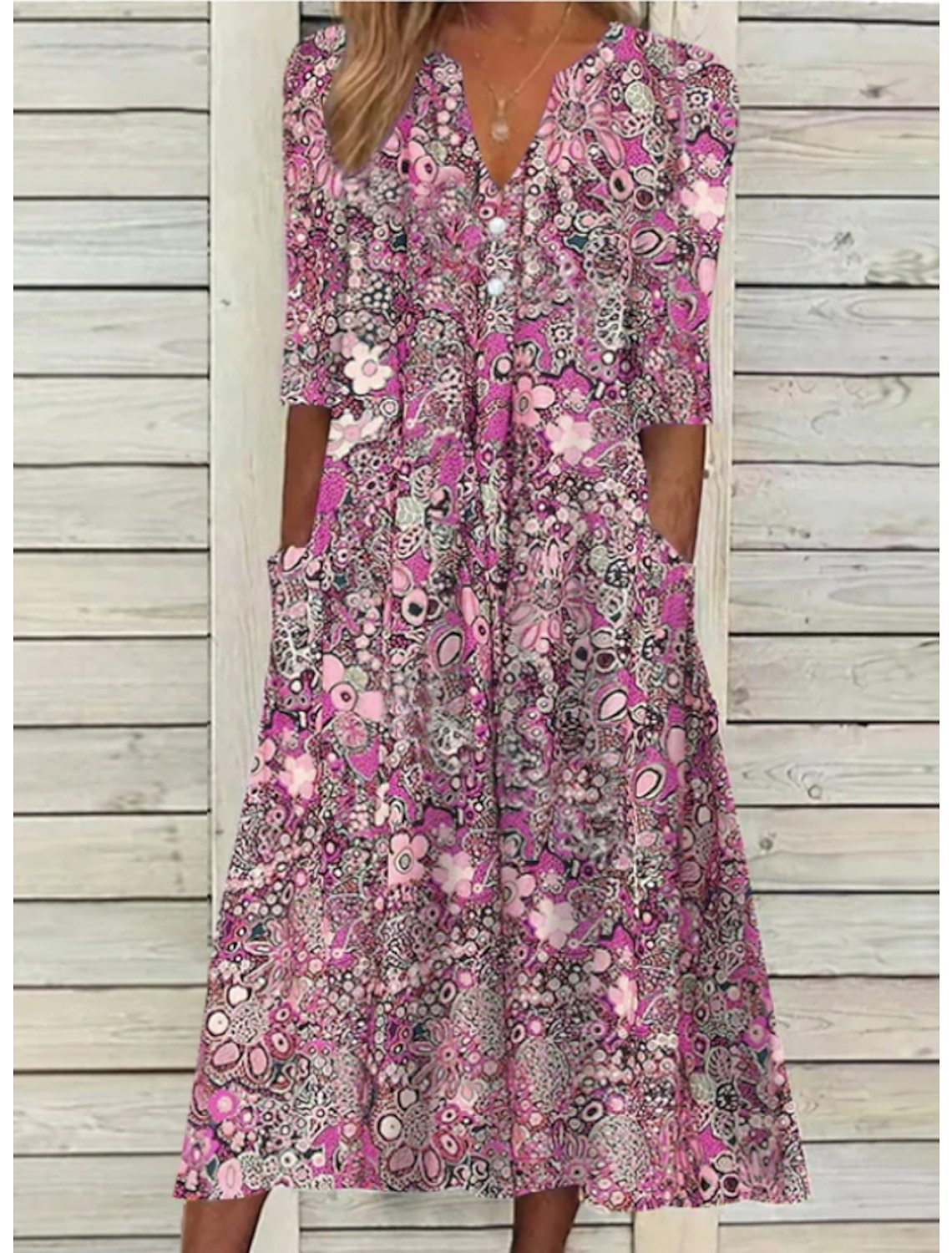 Woman wearing a floral dress with a wooden background