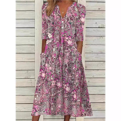 Woman wearing a pink floral dress against a wooden background