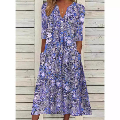 Woman wearing a blue floral dress against a wooden background