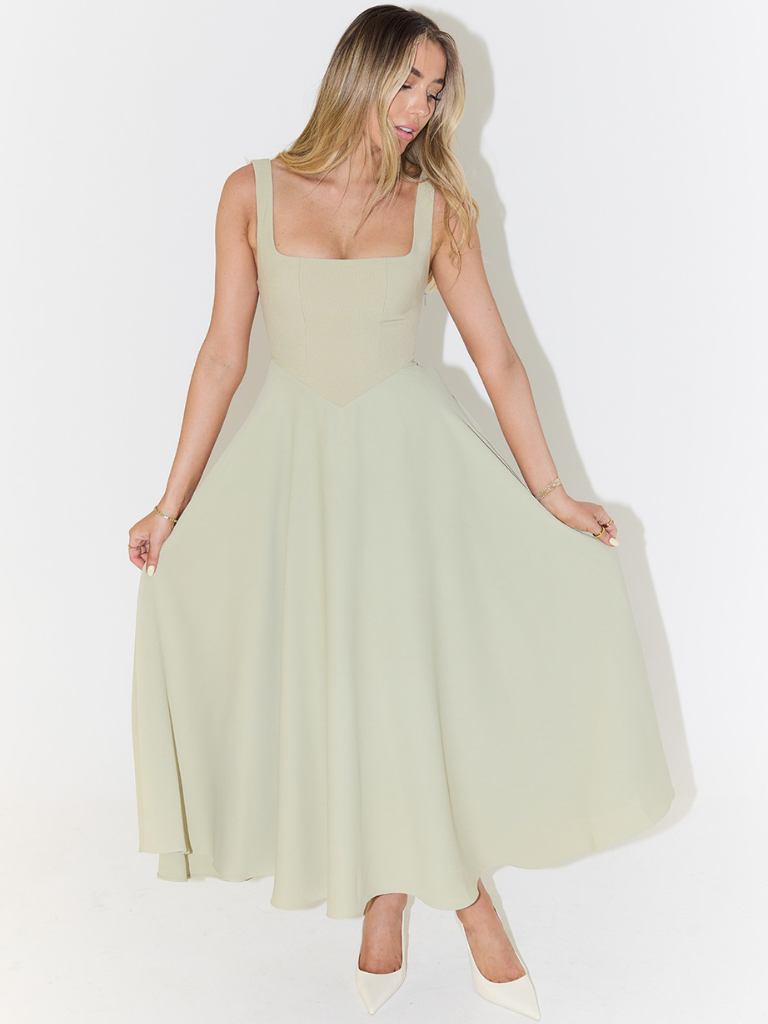 Woman wearing a light green dress on a white background