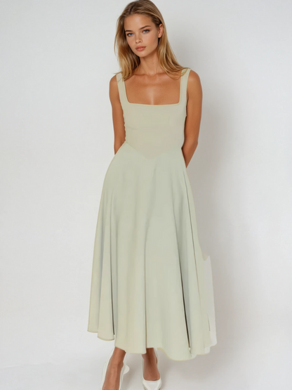 Woman wearing a light green dress against a white background