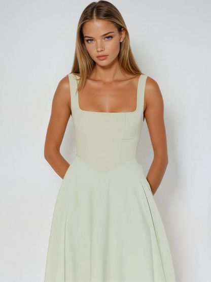 Woman wearing a light green dress against a white background