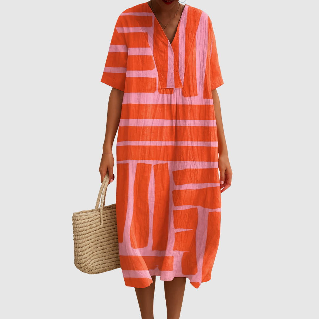 Person wearing an orange and pink striped dress holding a woven bag on a light gray background