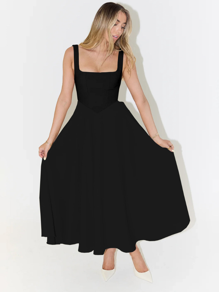Woman wearing a black dress against a white background
