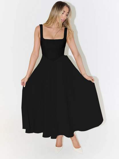 Woman wearing a black dress against a white background