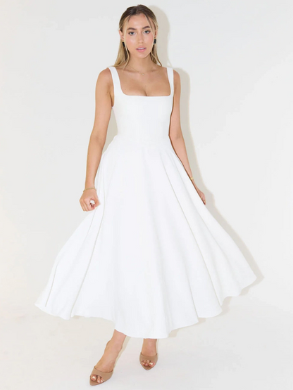 Woman wearing a white dress on a plain background