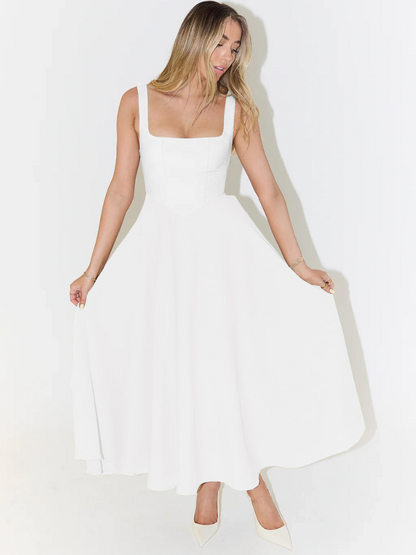 Woman wearing a white dress against a white background