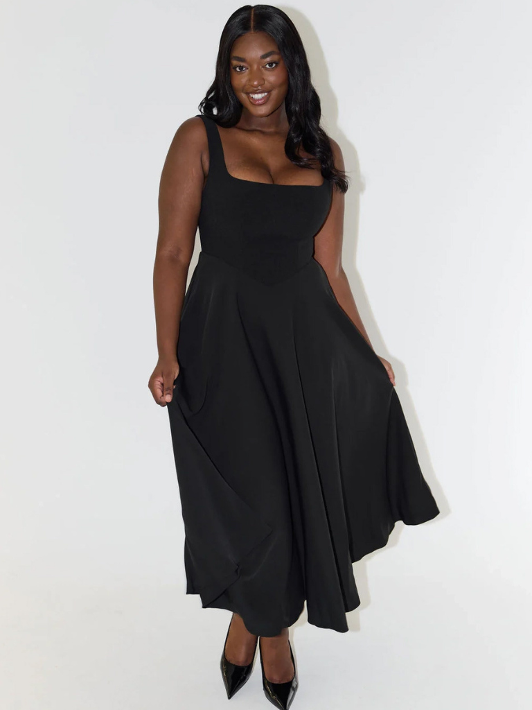 Woman wearing a black dress on a white background