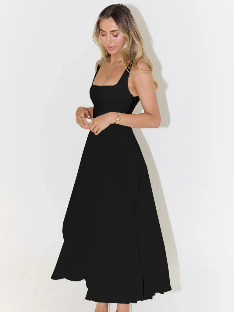 Woman wearing a black dress against a white background