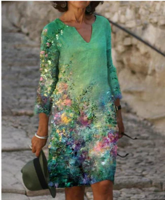 Woman wearing a colorful floral dress with a stone wall background