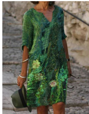 Person wearing a green floral dress on a stone path