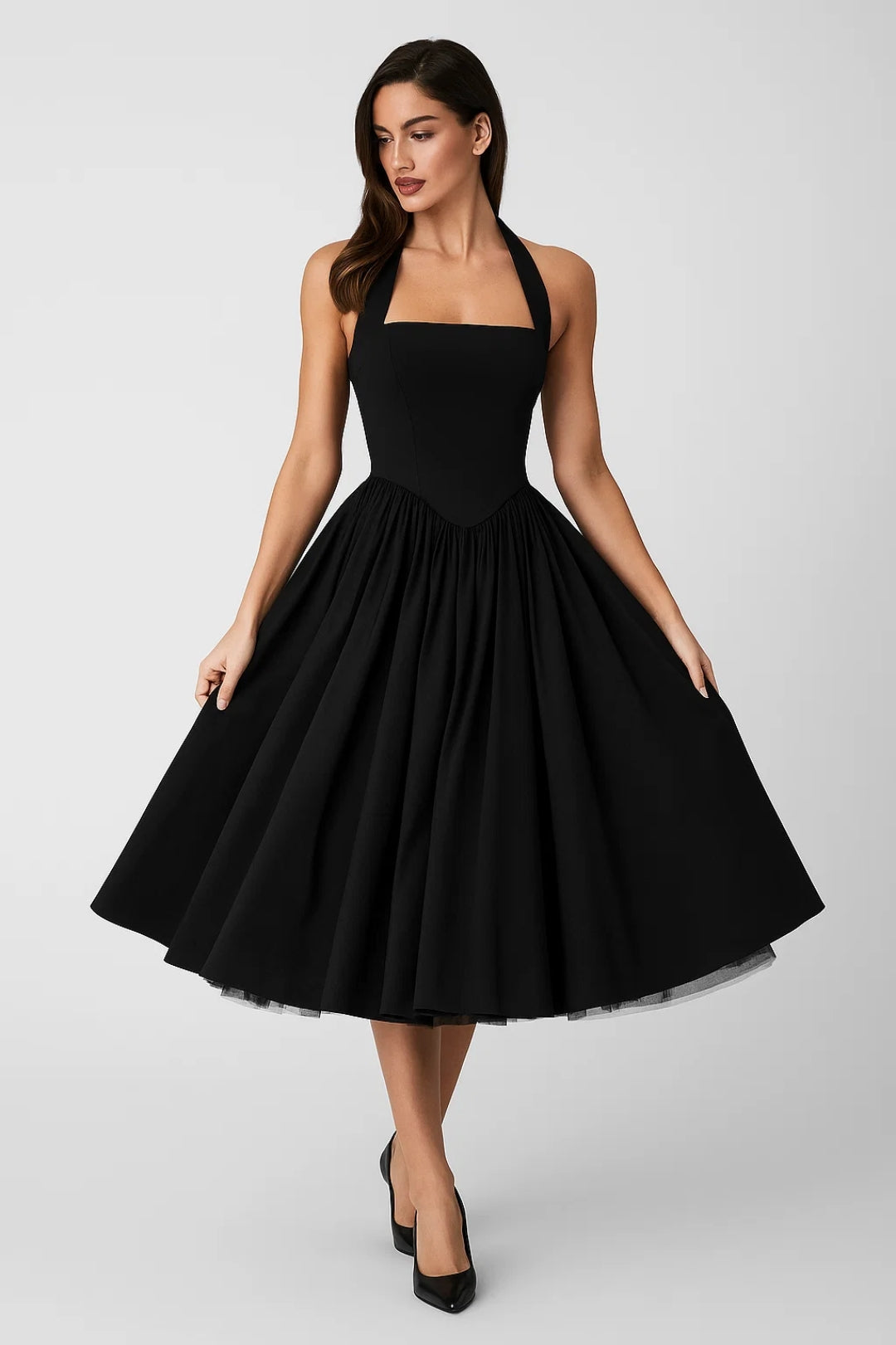 Woman wearing a black halter neck dress on a white background