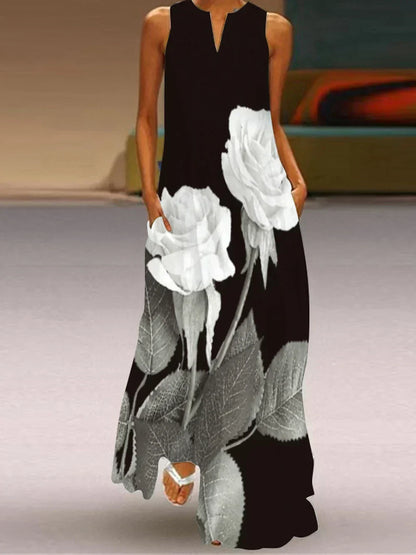 Black sleeveless dress with white floral design on a neutral background