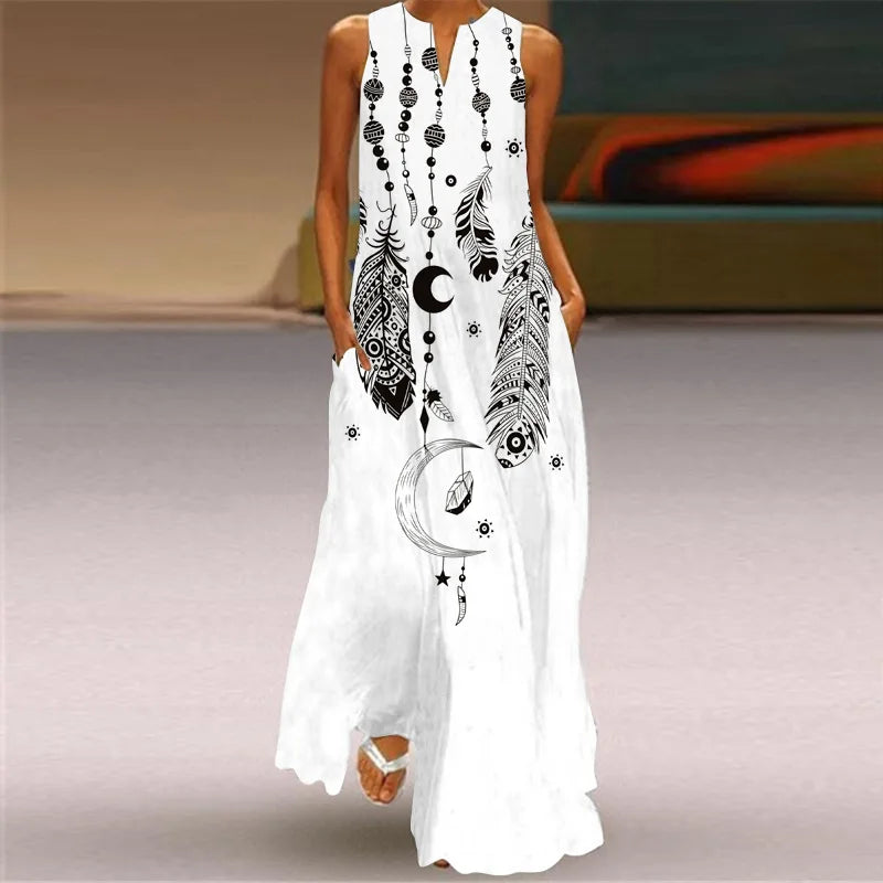 White sleeveless dress with black feather and moon designs on a neutral background