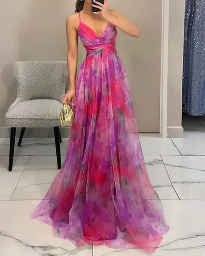 Woman wearing a colorful evening gown in a room with a chair and mirror.