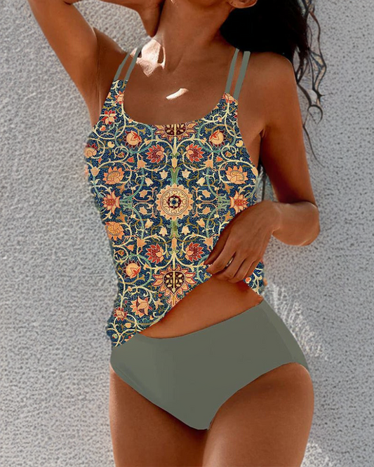 Woman wearing a floral-patterned swimsuit with a plain background