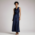 Woman wearing a navy blue dress against a plain background