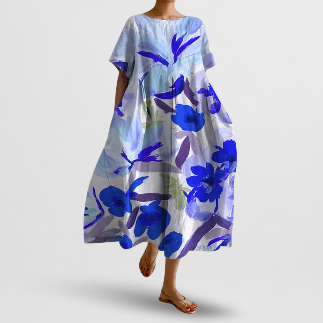 Woman wearing a blue floral dress on a plain background