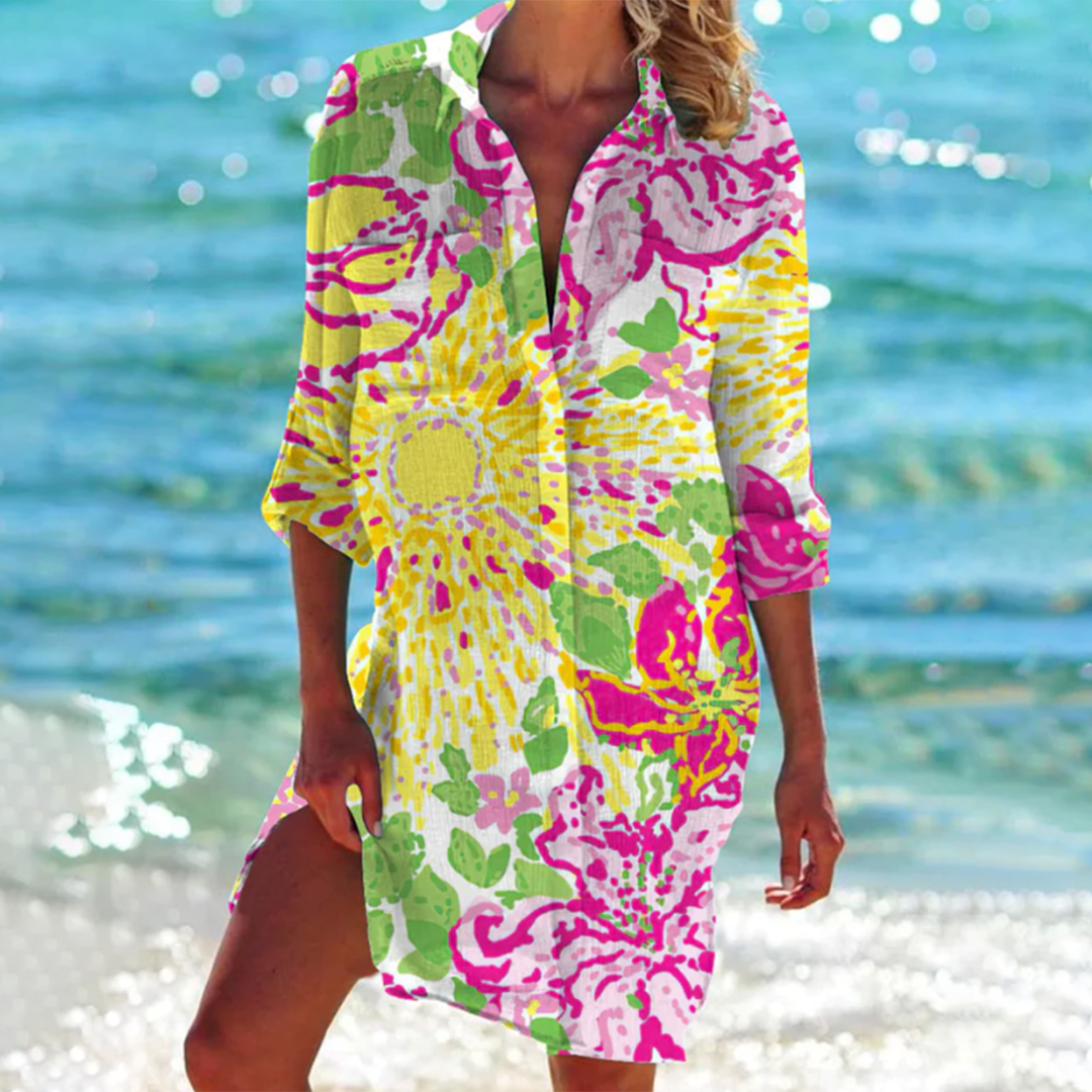 Woman wearing a colorful patterned dress on a beach