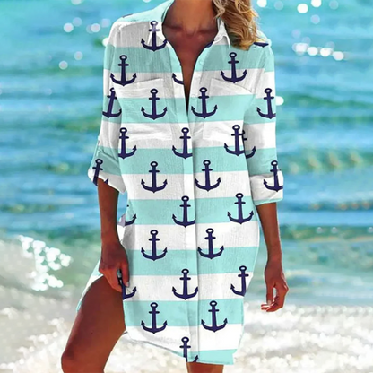 Person wearing a cover-up with anchor pattern by the beach