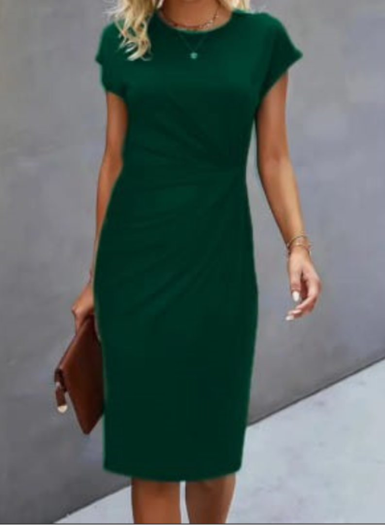 Woman wearing a green dress against a gray background