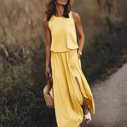 Woman in a yellow dress walking on a path with a blurred natural background